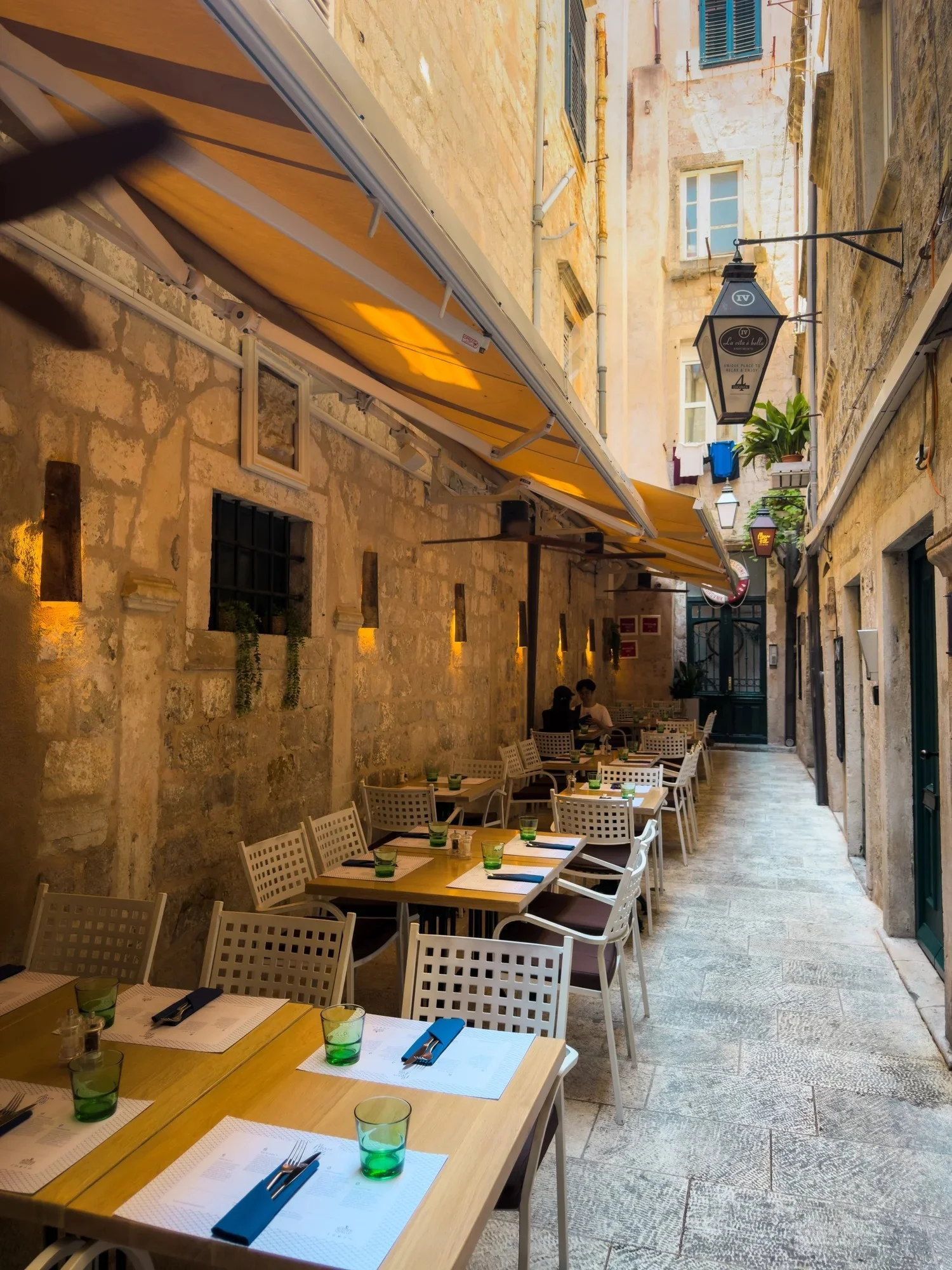 Outdoor tables along a narrow stone street at Restaurant Marco Polo in Dubrovnik