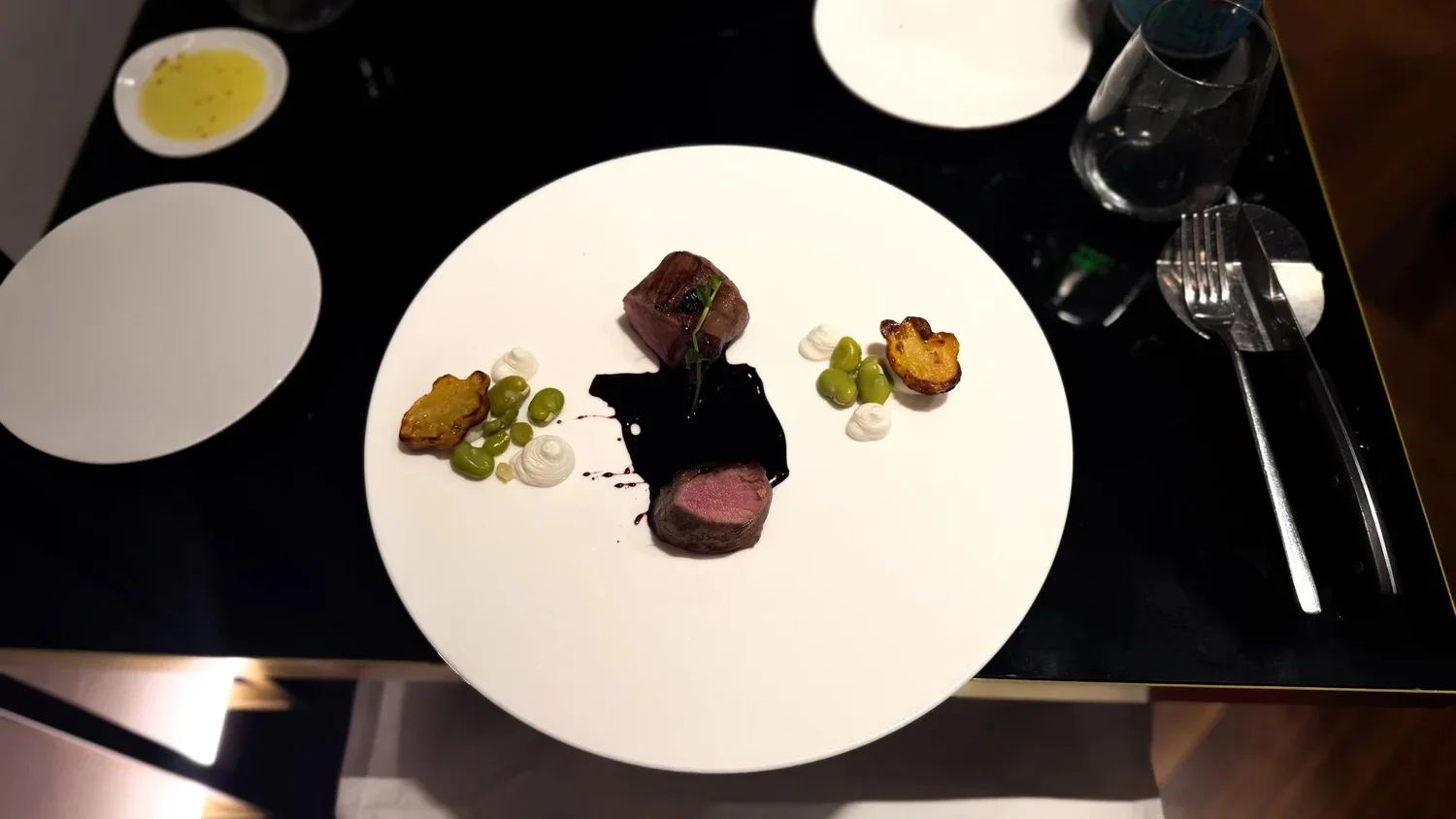 Veal served with dark Nero d’Avola sauce and vegetables at CR21 in Palermo.