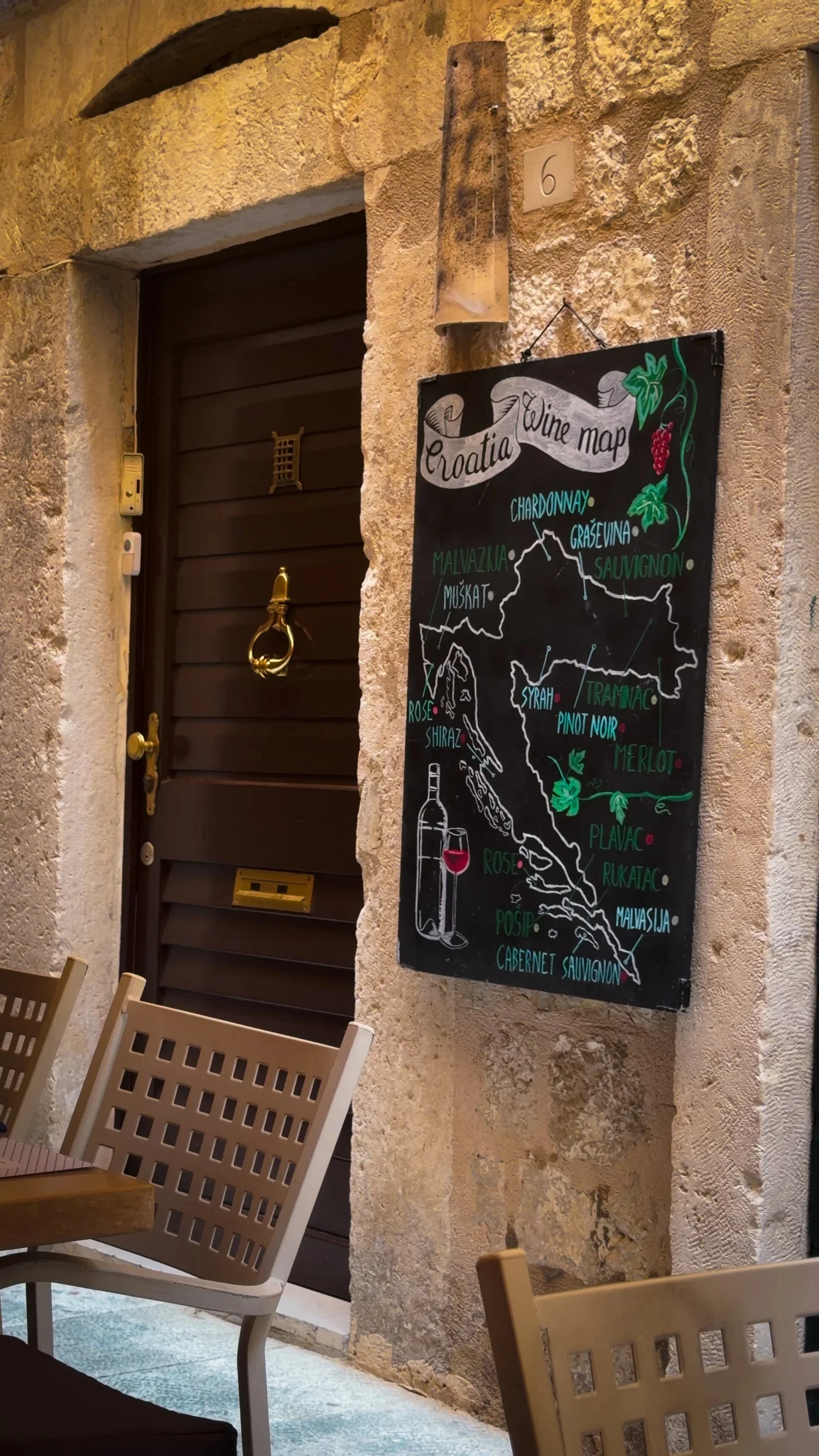 Stone doorway and chalkboard outside Restaurant Marco Polo