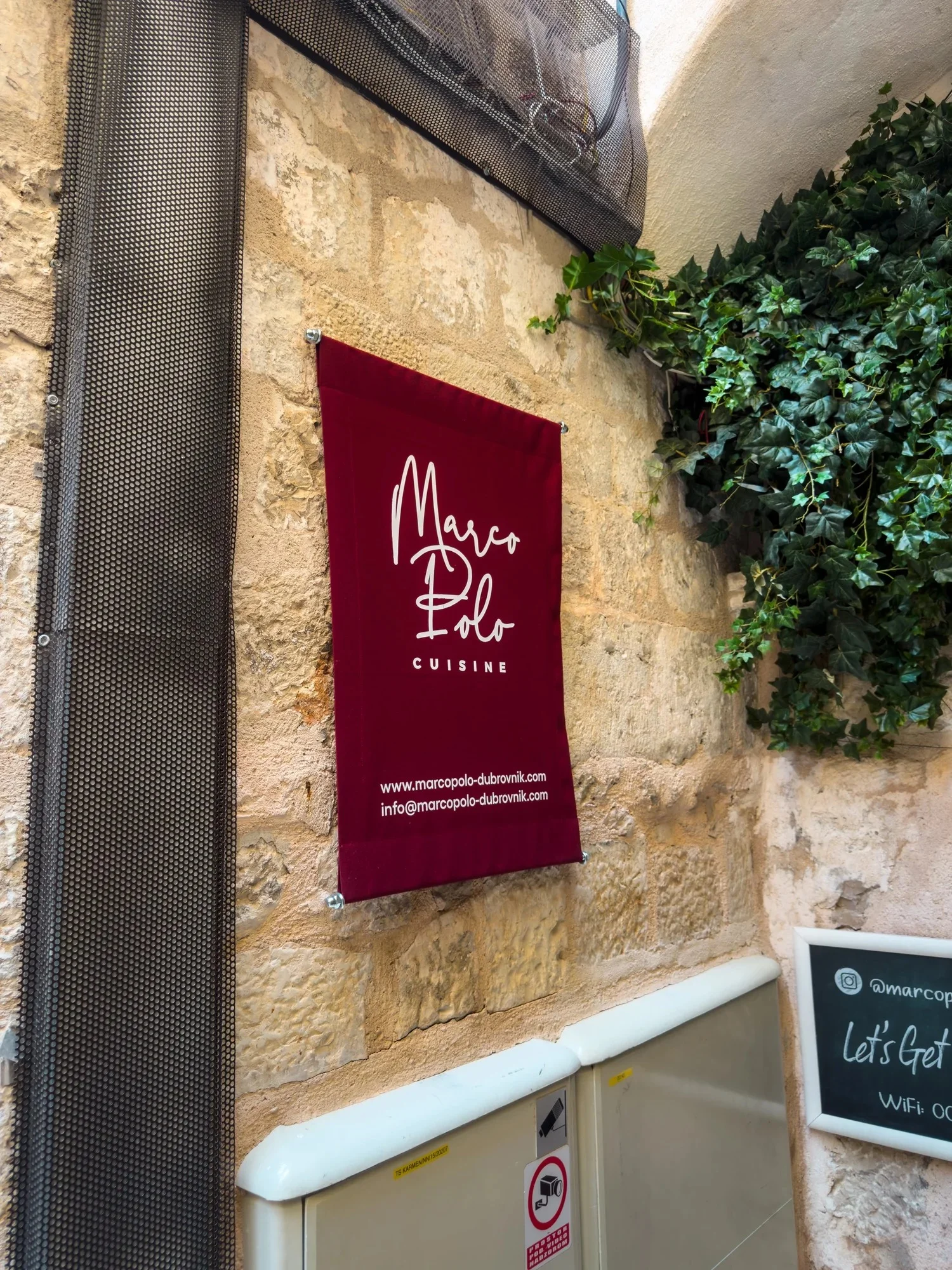Burgundy Restaurant Marco Polo sign on a stone wall