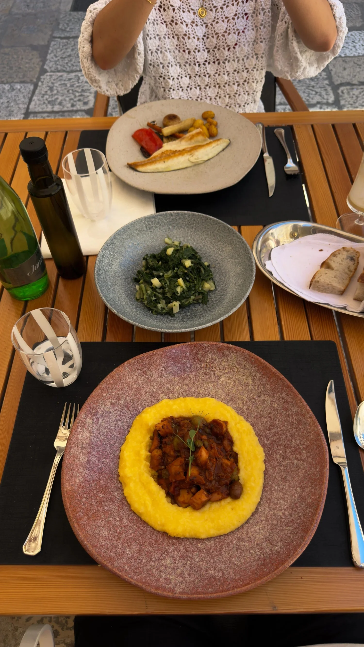 Octopus ragù with polenta and side dishes at Fish Restaurant Proto
