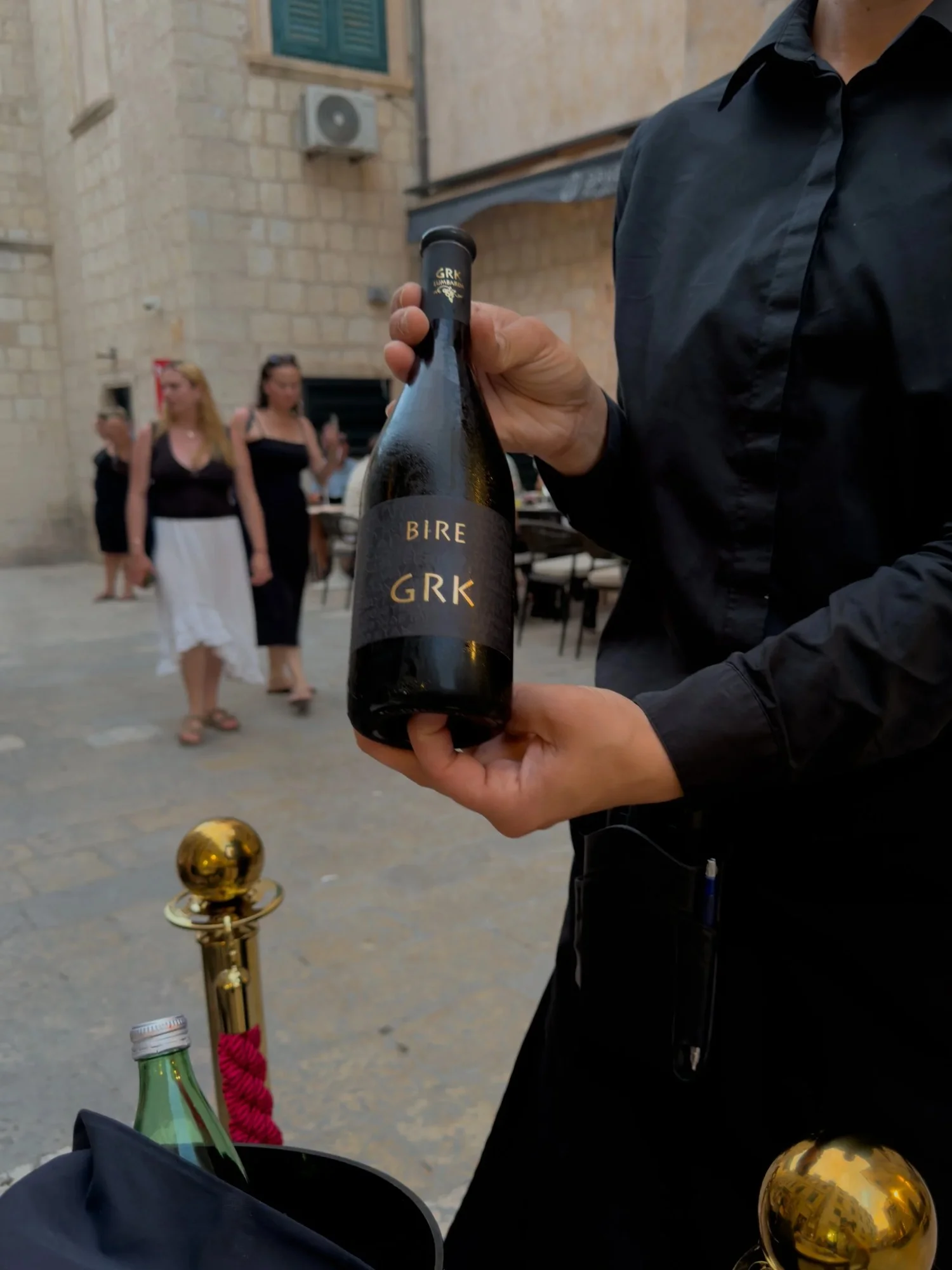 A waiter presenting Croatian wine at Restaurant Arka in Dubrovnik
