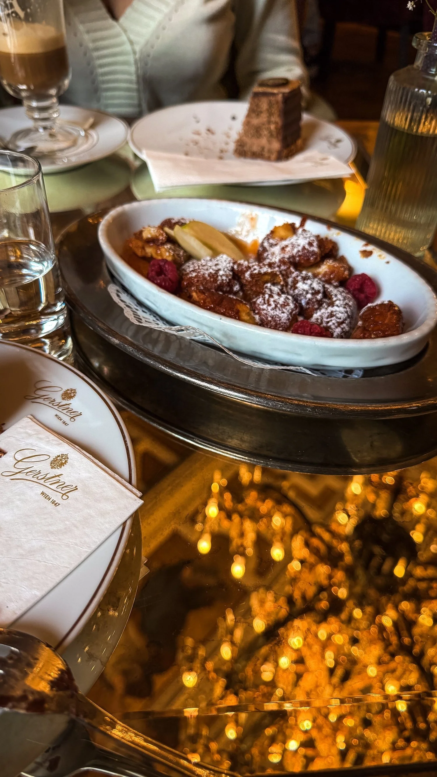 Kaiserschmarrn dusted with icing sugar and served in a metal dish.