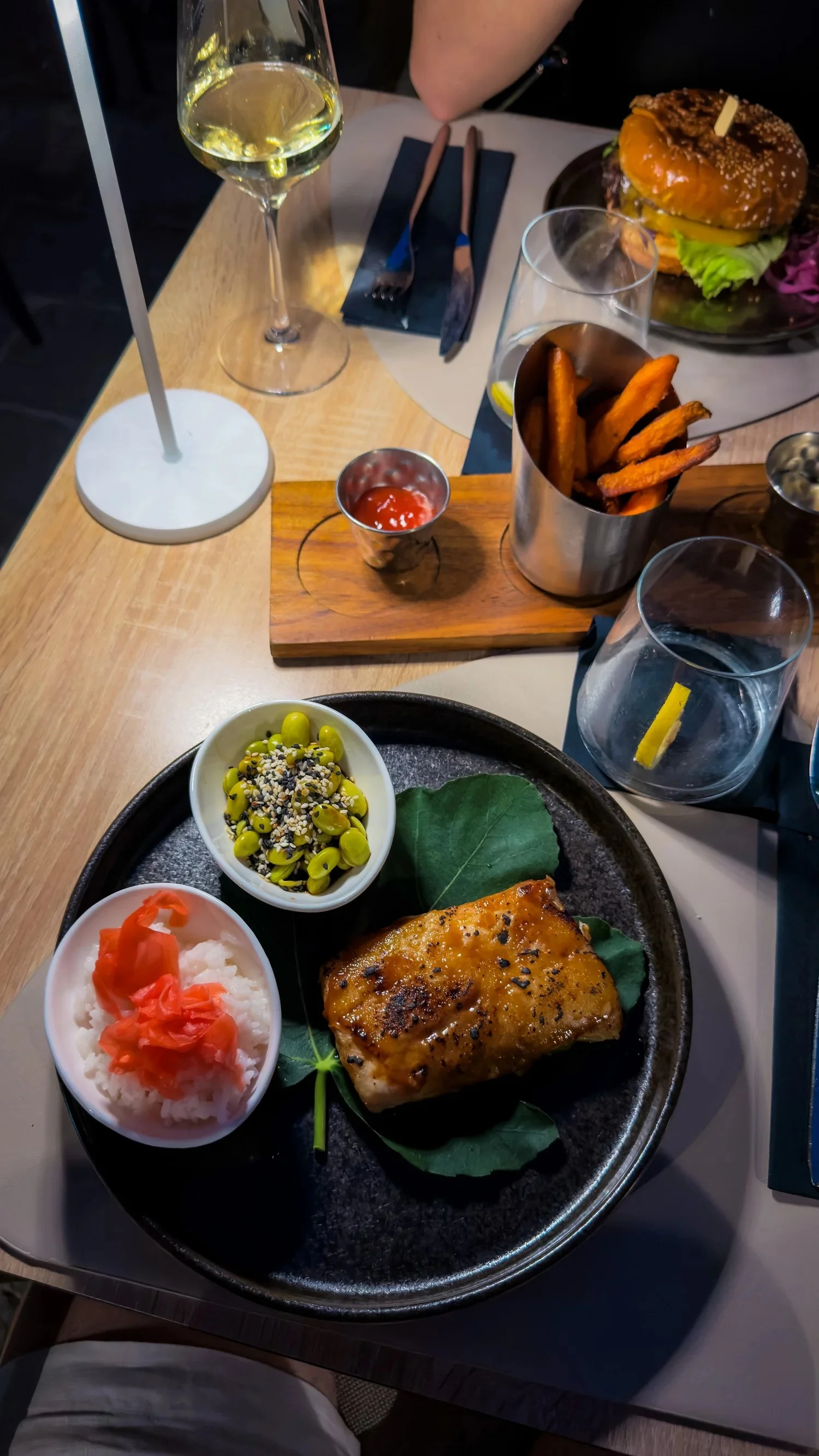 Miso black cod, a burger and side dishes at Restaurant Arka