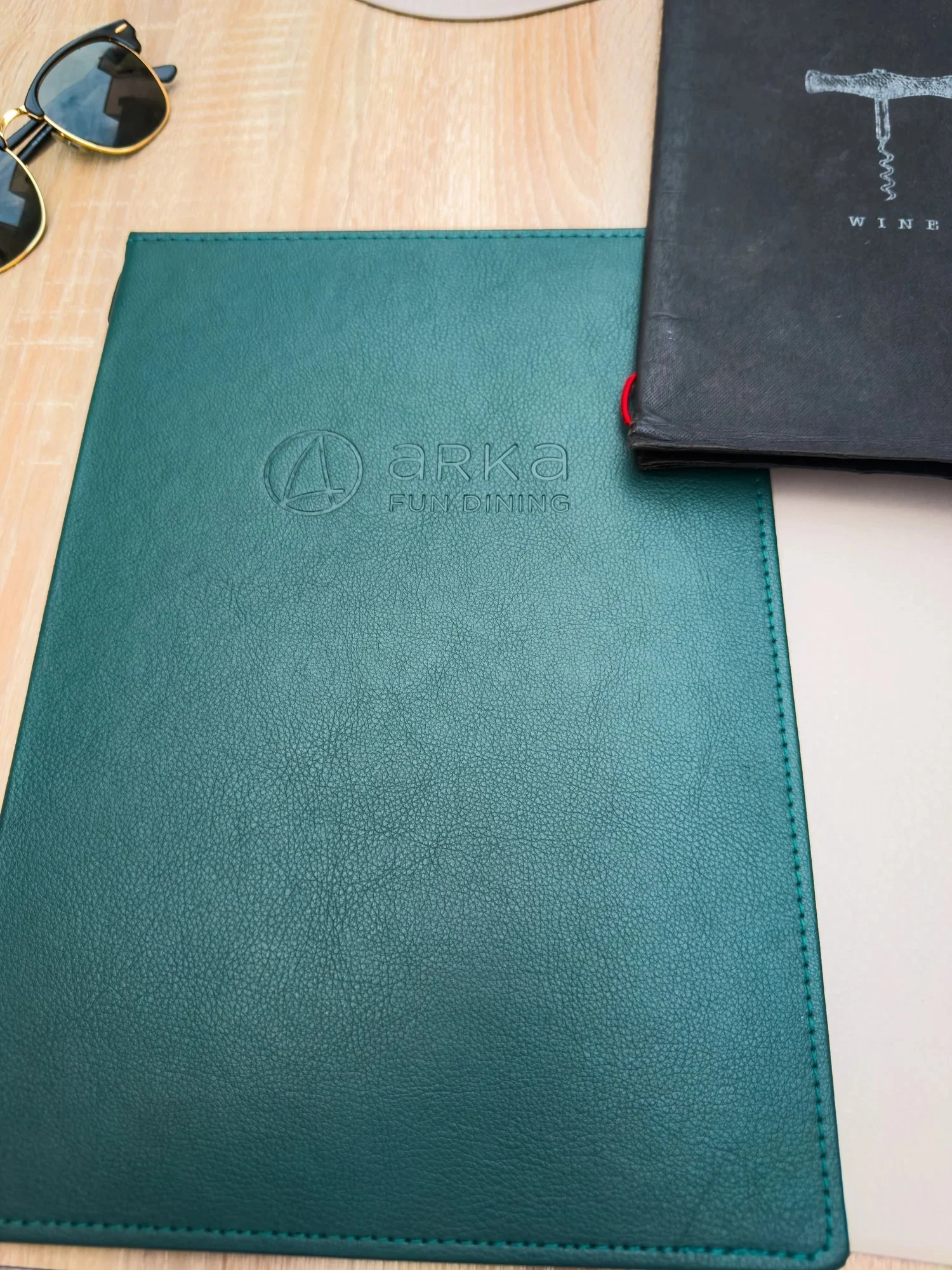 Green Restaurant Arka menu on a wooden dining table